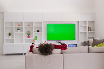 Image showing young man in bathrobe enjoying free time