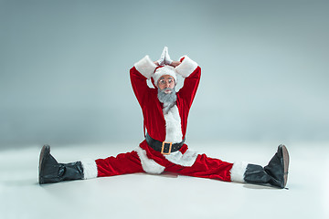 Image showing Funny guy in christmas hat. New Year Holiday. Christmas, x-mas, winter, gifts concept.