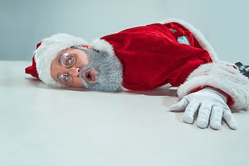 Image showing red white santa claus overworked frustration burnout concept lying on floor isolated on white background