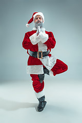 Image showing Funny guy in christmas hat. New Year Holiday. Christmas, x-mas, winter, gifts concept.