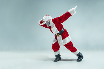 Image showing Funny guy in christmas hat. New Year Holiday. Christmas, x-mas, winter, gifts concept.