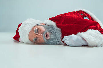 Image showing red white santa claus overworked frustration burnout concept lying on floor isolated on white background
