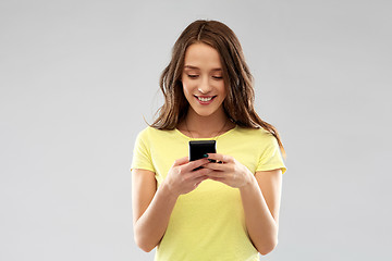 Image showing young woman or teenage girl using smartphone
