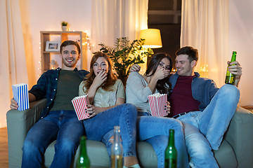 Image showing friends with beer and popcorn watching tv at home