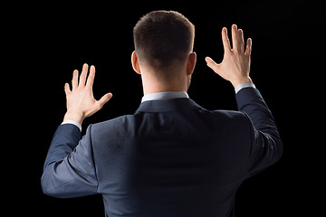 Image showing businessman working with invisible virtual screen