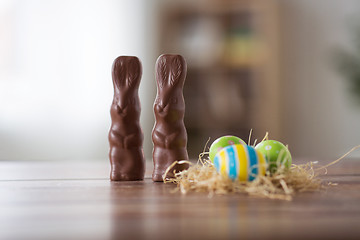 Image showing easter eggs in straw nest and chocolate bunnies