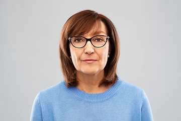 Image showing portrait of senior woman in glasses over grey