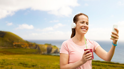 Image showing woman with smartphone and shake listening to music