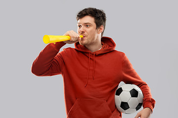 Image showing football fan with soccer ball blowing horn