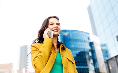 Image showing smiling young woman or girl calling on smartphone