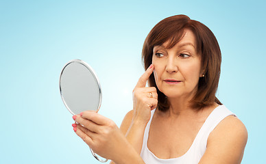 Image showing portrait of smiling senior woman with mirror