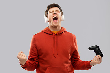 Image showing man or or gamer with gamepad winning in video game