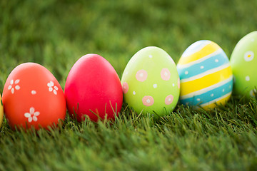 Image showing row of colored easter eggs on artificial grass