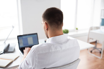 Image showing close up of businessman typing on laptop at office