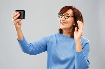 Image showing senior woman having video call on smartphone