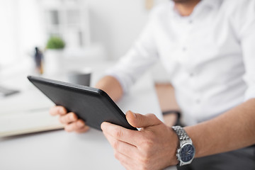 Image showing close up of businessman with tablet pc at office