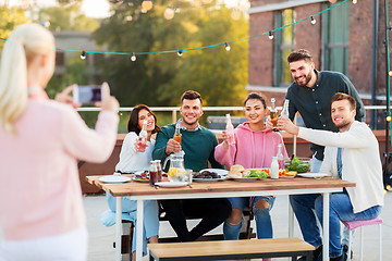 Image showing happy friends photographing at rooftop party