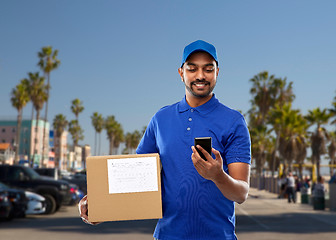 Image showing indian delivery man with smartphone and parcel box