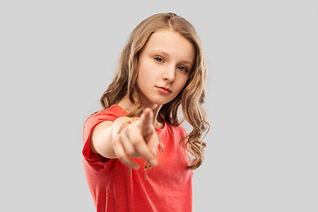 Image showing teenage girl in red t-shirt pointing finger to you