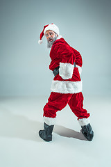 Image showing Funny guy in christmas hat. New Year Holiday. Christmas, x-mas, winter, gifts concept.