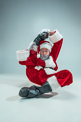 Image showing Funny guy in christmas hat. New Year Holiday. Christmas, x-mas, winter, gifts concept.