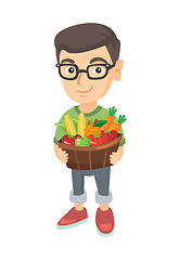 Image showing Boy holding basket with fruit and vegetables.