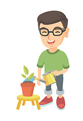 Image showing Caucasian boy watering plant with a watering can.