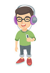 Image showing Caucasian boy listening to music in headphones.