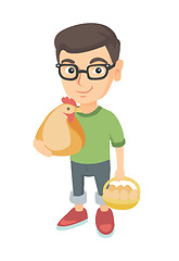 Image showing Caucasian boy holding a chicken and hen eggs.