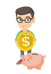 Image showing Caucasian boy putting a coin into a piggy bank.