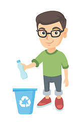 Image showing Boy throwing plastic bottle in recycle bin.