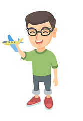 Image showing Caucasian cheerful boy playing with a toy airplane