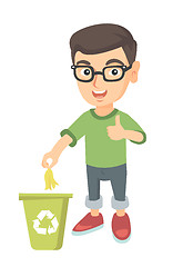 Image showing Little boy throwing banana peel in recycling bin.