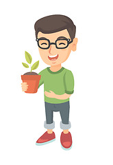 Image showing Caucasian smiling boy holding a potted plant.