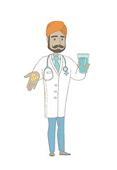 Image showing Young pharmacist giving pills and glass of water.