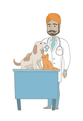 Image showing Young indian veterinarian examining pets.