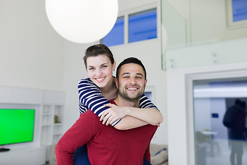 Image showing handsome man piggybacking his girlfriend