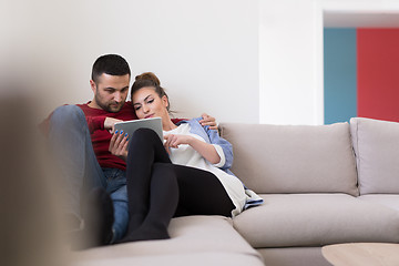 Image showing couple relaxing at  home with tablet computers