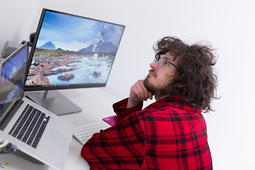 Image showing graphic designer in bathrobe working at home