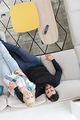 Image showing Young couple on the sofa watching television top view