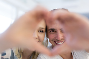 Image showing couple making heart with hands