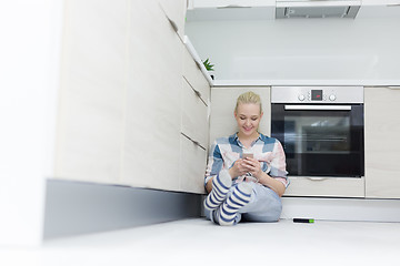 Image showing young women using mobile phone at home