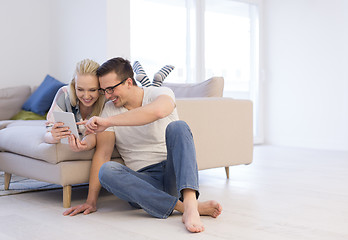 Image showing couple relaxing at  home with tablet computers