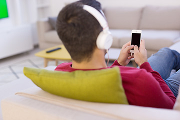 Image showing man enjoying music through headphones