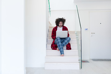 Image showing freelancer in bathrobe working from home