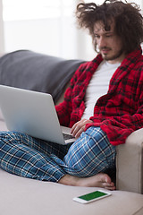 Image showing man freelancer in bathrobe working from home