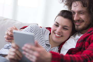 Image showing couple relaxing at  home with tablet computers