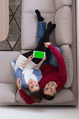 Image showing couple relaxing at  home with tablet computers