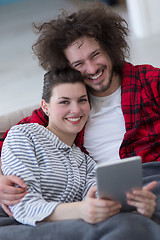 Image showing couple relaxing at  home with tablet computers