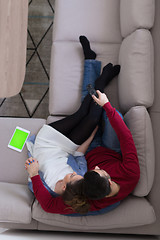 Image showing Young couple on the sofa watching television top view